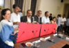 Kabaddi Association members and university officials posing with Kabaddi mats during the handover programme at Cluster University Jammu.