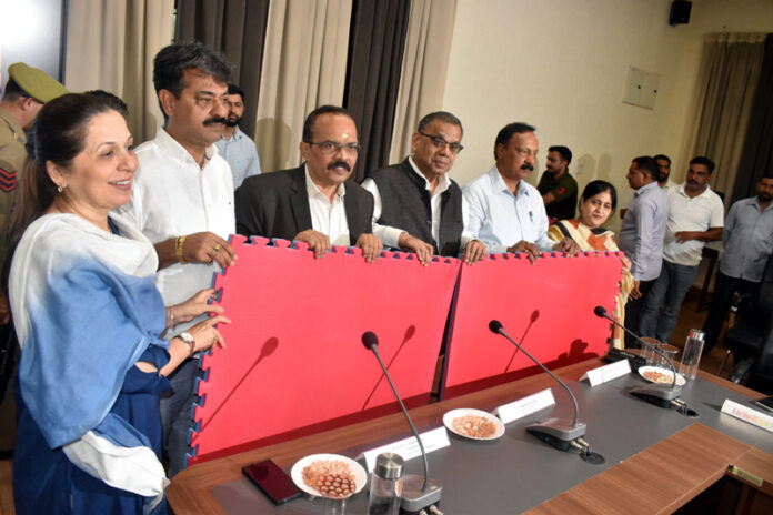 Kabaddi Association members and university officials posing with Kabaddi mats during the handover programme at Cluster University Jammu.