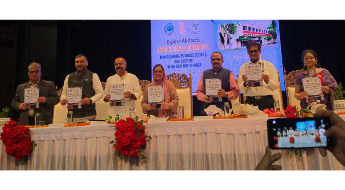 Guests on dais releassing conferendce abstract book during inaugural function.