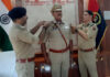 Commandant 1st Women Battalion, RC Kotwal, pinning rank on newly promoted police personnel.