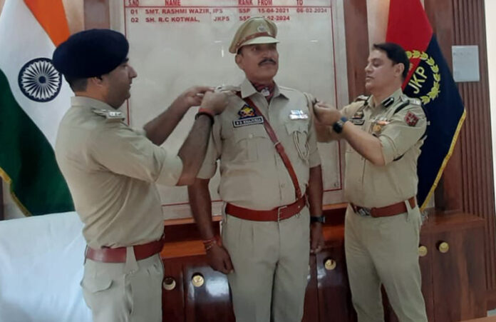 Commandant 1st Women Battalion, RC Kotwal, pinning rank on newly promoted police personnel.