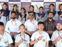 Students posing along with school management.