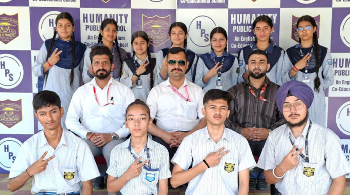 Students posing along with school management.
