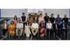 Dignitaries posing along with participants from different Universities during an event.
