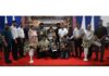 Chess players posing along with certificates during a programme.