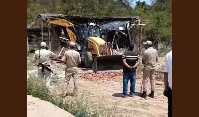 Illegal structure constructed on Government land by ex Vice Chairman of DDC Samba being demolished in Sumb area on Friday. -Excelsior/Nischant
