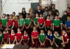 Dignitaries posing with young participants during the programme.