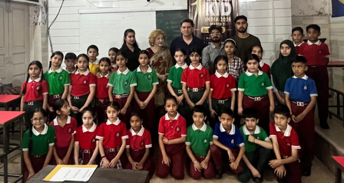 Dignitaries posing with young participants during the programme.