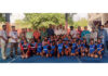 Players posing along with dignitaries during an event.