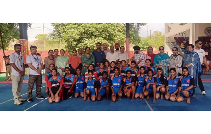 Players posing along with dignitaries during an event.