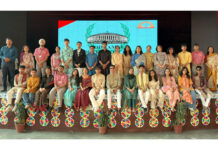 Dignitaries posing along with participants during a programme.