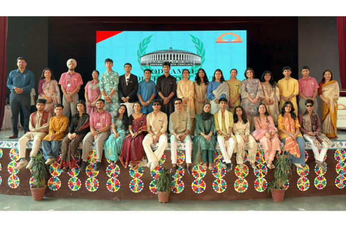 Dignitaries posing along with participants during a programme.