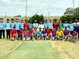 Players posing along with dignitaries during an event.