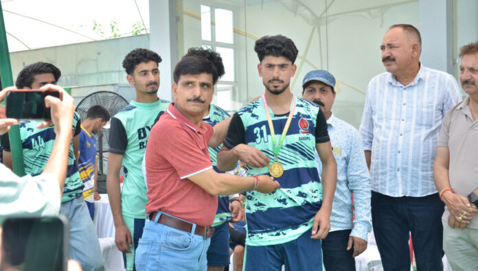 Dignitary presenting medal to players during a programme.