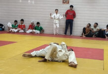 Judo players in action during a match.