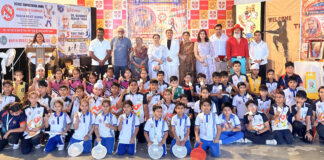 Students posing along with dignitaries during a programme.