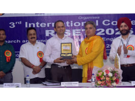 BJP leader Ravinder Raina receiving memento from College management.