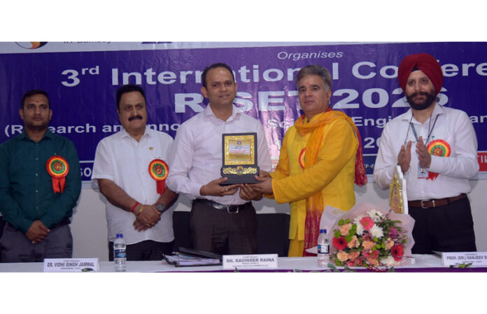 BJP leader Ravinder Raina receiving memento from College management.