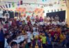 Participants posing along with dignitaries during an event.