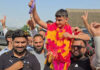 Asian gold medalist Mohammad Yasser displaying his medal during his grand reception in Rajouri on Friday.