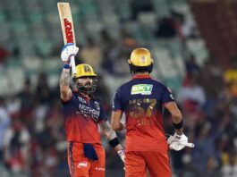Virat Kohli raising his bat after scoring an unbeaten 105 runs against KKR in Raipur.