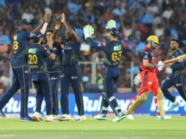 Gujarat Titans bowler celebrating with teammates after taking wicket of Virat Kohli in Ahmedabad.