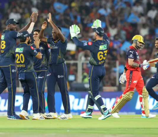 Gujarat Titans bowler celebrating with teammates after taking wicket of Virat Kohli in Ahmedabad.