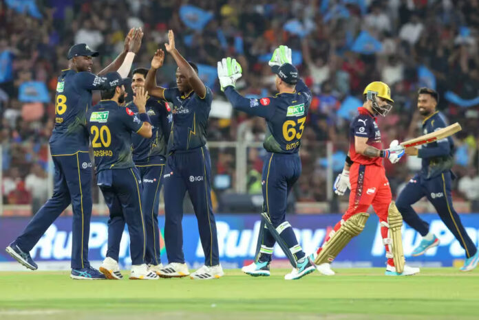Gujarat Titans bowler celebrating with teammates after taking wicket of Virat Kohli in Ahmedabad.