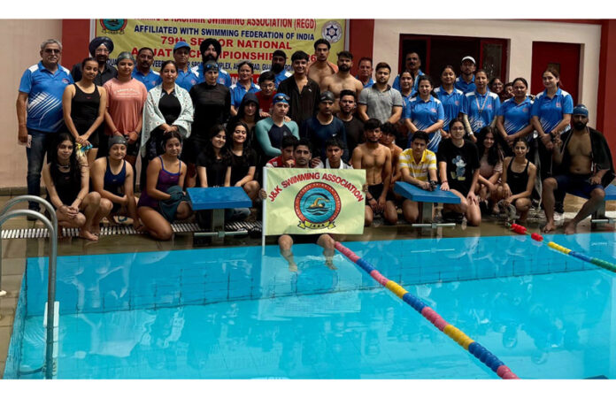 Swimmers posing along with dignitaries during selection trials.
