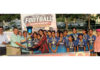 Winning team posing along with trophy during prize distribution ceremony.
