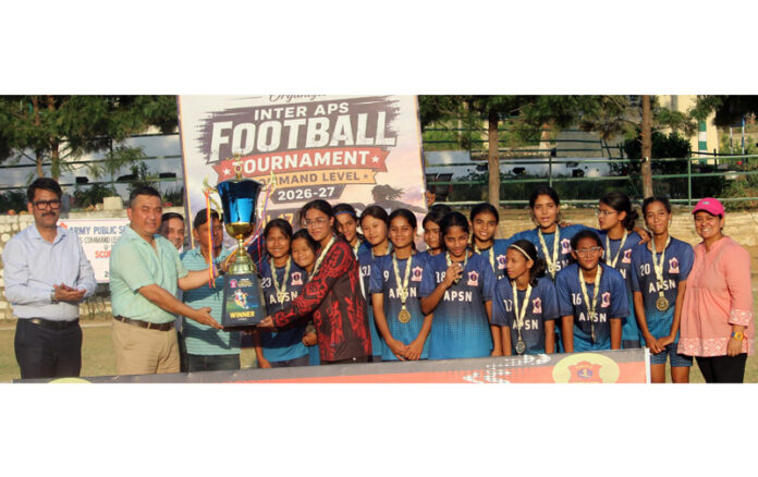 Winning team posing along with trophy during prize distribution ceremony.