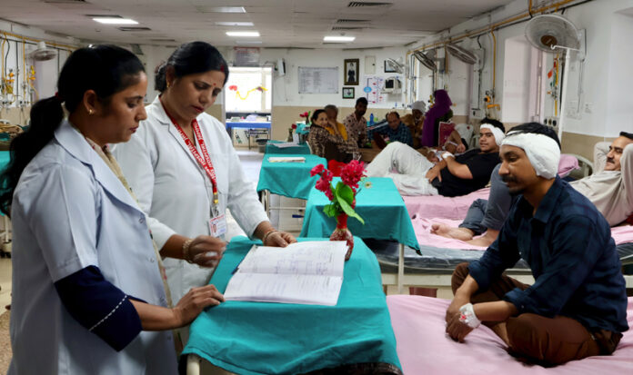 Nurses attend to patients in a hospital ward on the occasion of International Nurses Day, in Jammu on Tuesday. (UNI)
