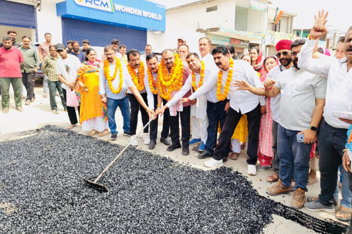 MLA Bahu, Ch Vikram Randhawa kick starting blacktopping work on Belicharana-Raipur Satwari road in Jammu on Tuesday.