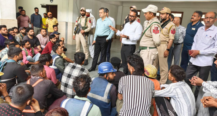 Workers of Nirman Vridhi Construction Company raising issues before Deputy Commissioner Ramban on Tuesday. —Excelsior/Parvez Mir