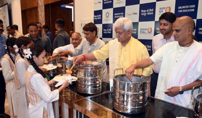 LG Manoj Sinha serving mid-day meal among the students in Katra on Thursday. LG Manoj Sinha serving mid-day meal among the students in Katra on Thursday.