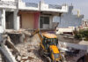 A JCB demolishing an alleged drug peddler's property in Miran Sahib area of Jammu district on Saturday. -Excelsior/Rakesh