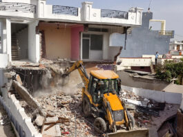 A JCB demolishing an alleged drug peddler's property in Miran Sahib area of Jammu district on Saturday. -Excelsior/Rakesh