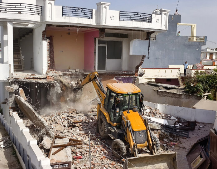 A JCB demolishing an alleged drug peddler's property in Miran Sahib area of Jammu district on Saturday. -Excelsior/Rakesh