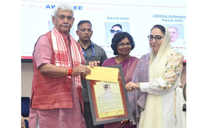 LG presenting award to Darakhshan Andrabi at Srinagar on Tuesday. —Excelsior/Shakeel
