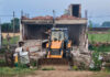 An illegal structure being demolished at Chak Avtara area in Bishnah town on Monday.