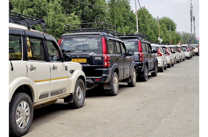 A row of parked vehicles linked to illegal roadside stands in Srinagar. -Excelsior/Shakeel