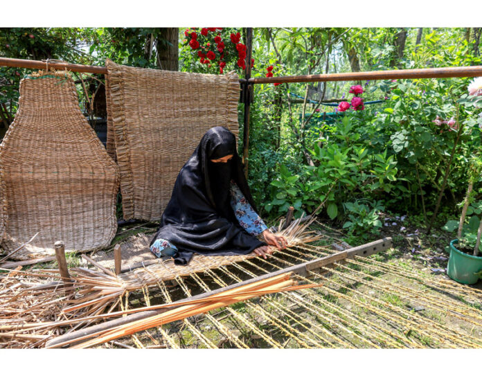 Mir Behri's Tanzeela - a Master's student in Persian making Waguv, traditional handwoven mat. -Excelsior/Shakeel