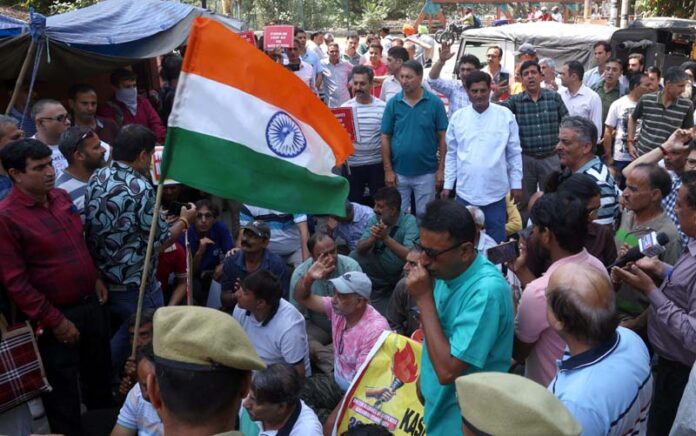 Kashmiri migrants holding protest in front of Relief and Rehabilitation Commissioner's office at Jammu on Wednesday. -Excelsior/Rakesh