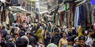 Shoppers throng a local market in Srinagar on Tuesday. -Excelsior/Shakeel