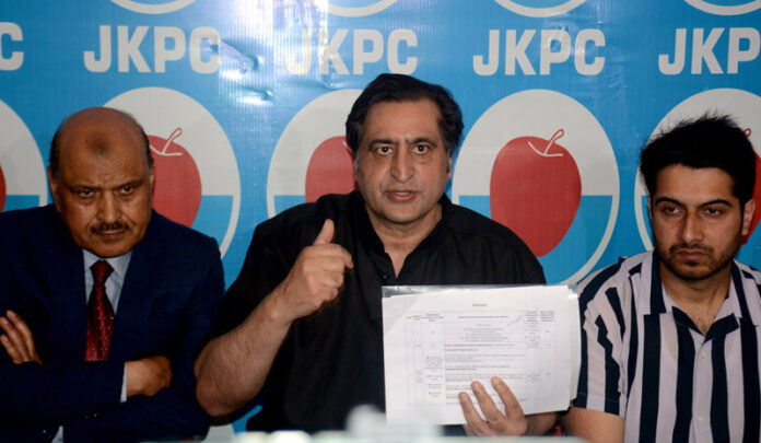 Peoples Conference President Sajad Lone along with other party leaders during a press conference in Srinagar on Monday. —Excelsior/Shakeel
