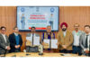 CPCO Amit Sharma and Vice-Chancellor of Ladakh University displaying copies of MoU signed by them.