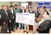 Justice Sanjeev Kumar giving claim cheque to a claimant on Saturday.