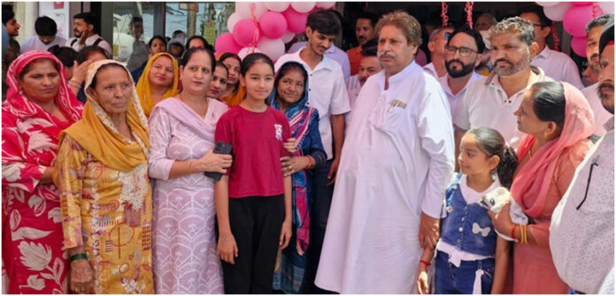 Senior JKPCC leader, Raman Bhalla interacting with people at Chatha Pind in Jammu South on Tuesday.
