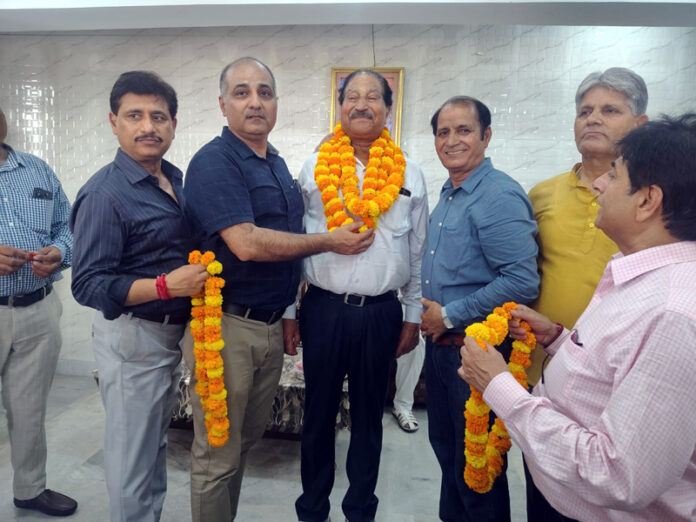 Newly elected president of Pradesh Vishwakarma Sabha, Raj Kumar Chalotra being felicitated by members in Jammu.