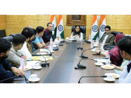Director Information chairing a meeting at Srinagar on Thursday.